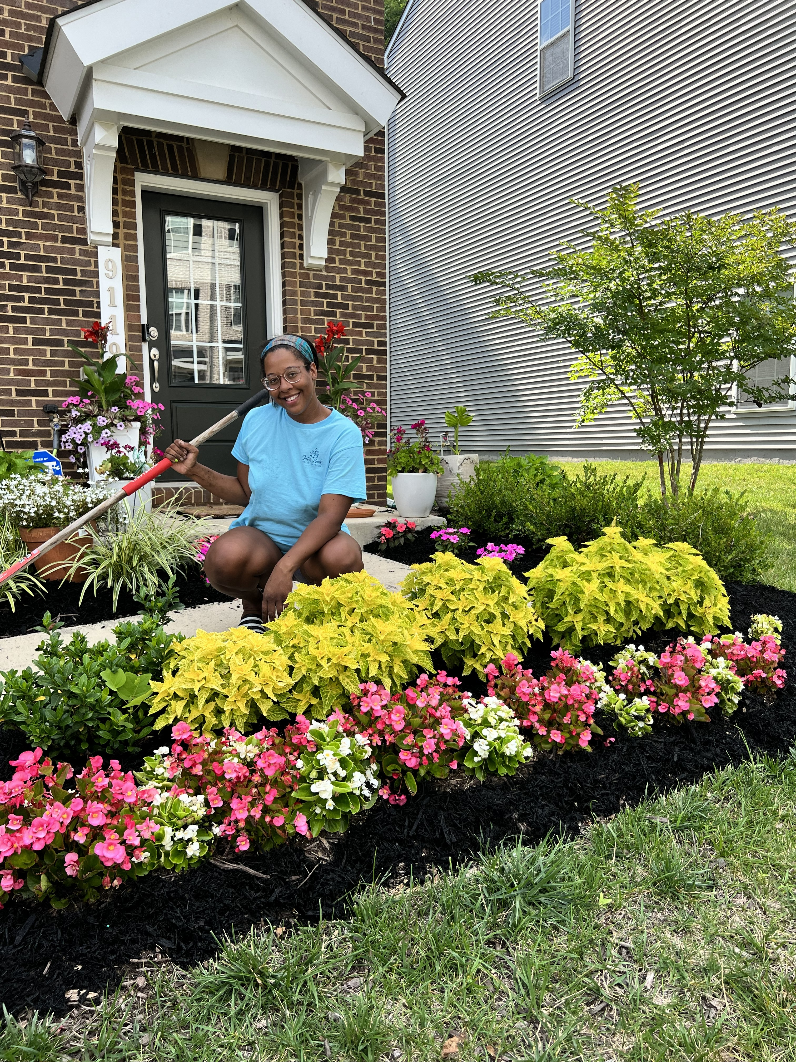 Kendra refreshing a garden bed